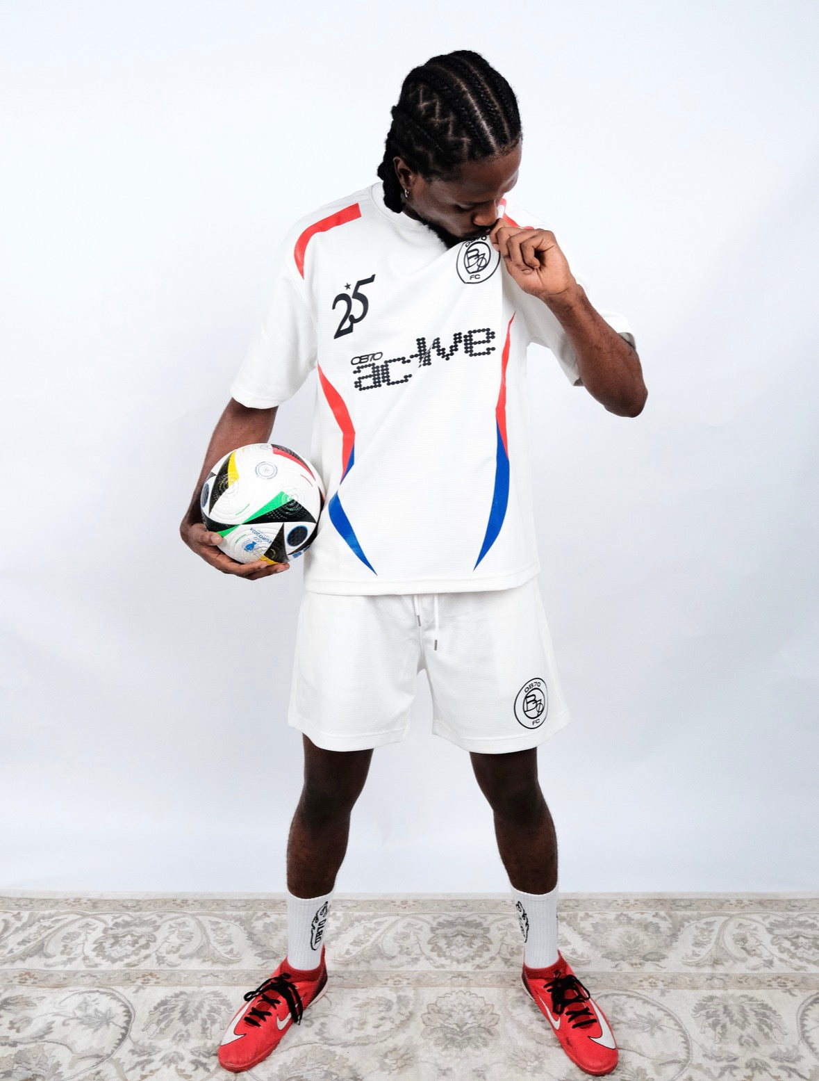 Person wearing OB70 Active Jersey with a soccer ball on a plain background