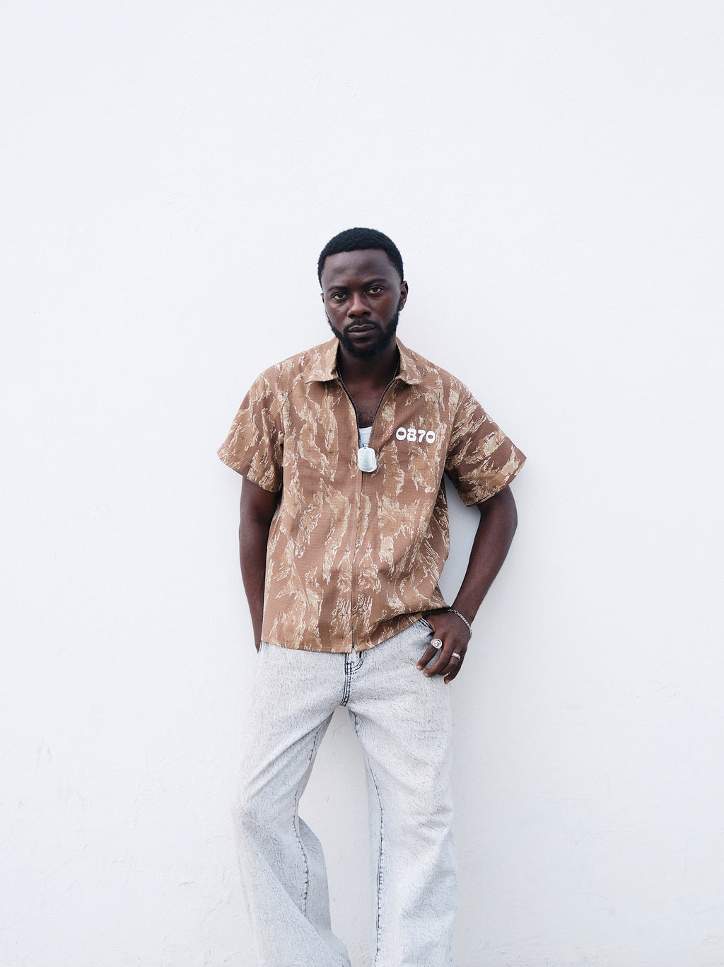 A closer short of Brown Camouflage short sleeve shirt o a model 