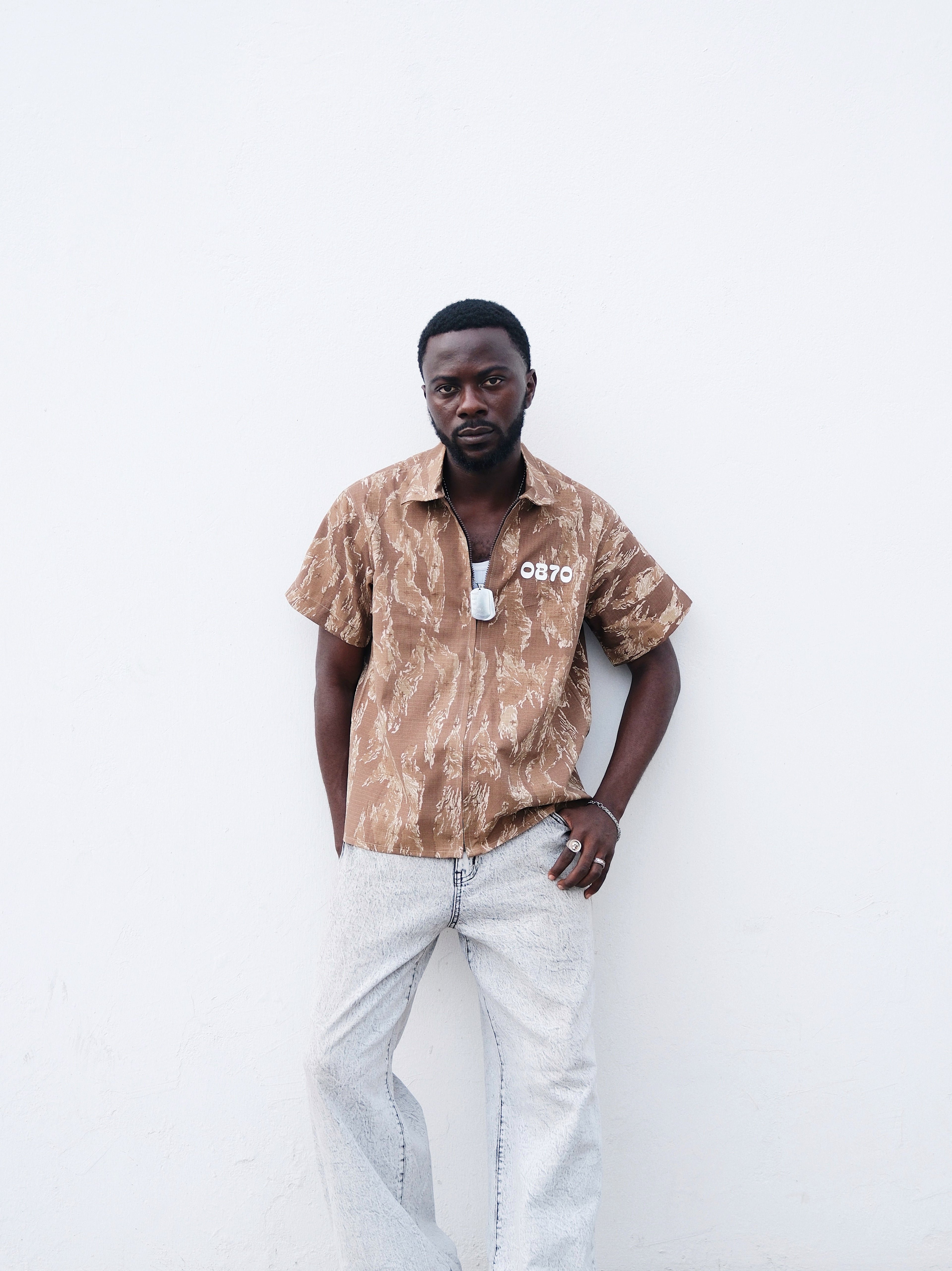 A closer short of Brown Camouflage short sleeve shirt o a model 