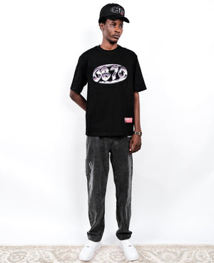 Person wearing a black OB70 Crab logo t-shirt, dark OB70 SS25 jeans, and white sneakers on a white background.