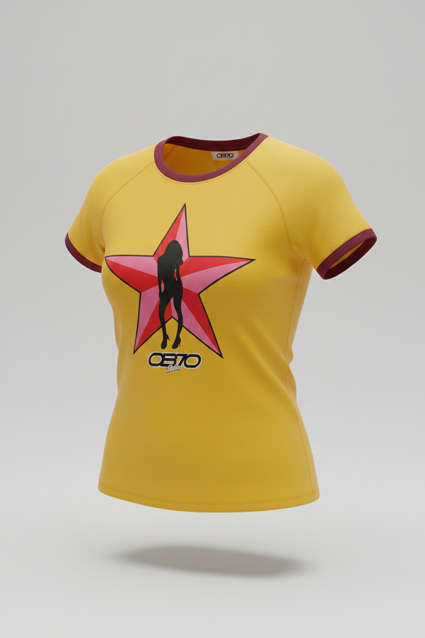 A yellow short-sleeve raglan t-shirt with dark brown trim on the collar and sleeve cuffs, featuring a large red star graphic on the chest with a black silhouette of a woman and the brand name 'OB70 Babes' printed below.