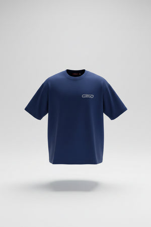 A royal blue short-sleeve athletic t-shirt with a small white 'OB70' logo on the left chest, laid flat on a gray textured tile floor.