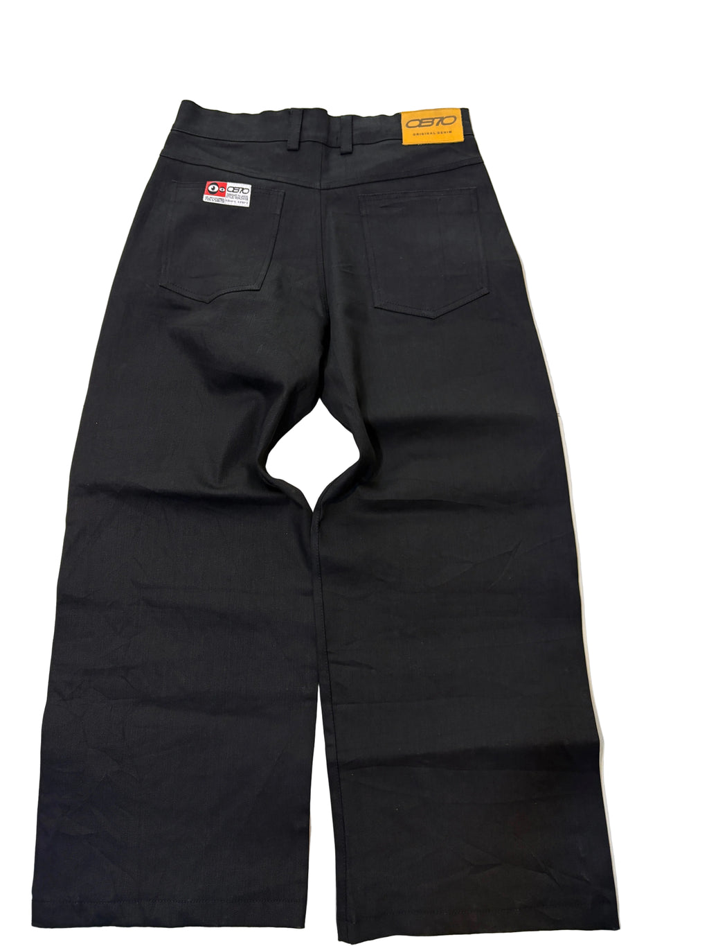 Black denim pants with a visible OB70 label on it