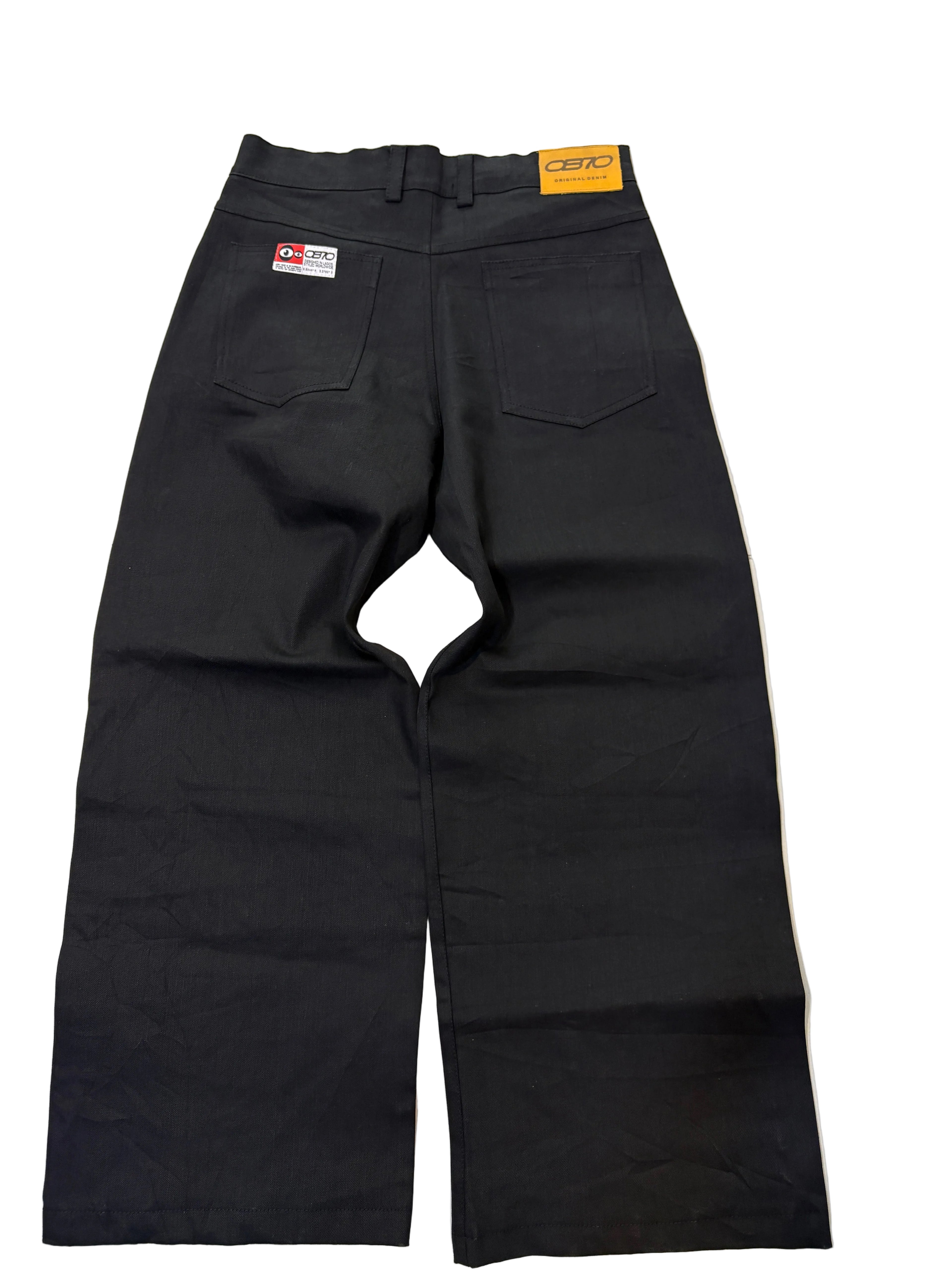Black denim pants with a visible OB70 label on it