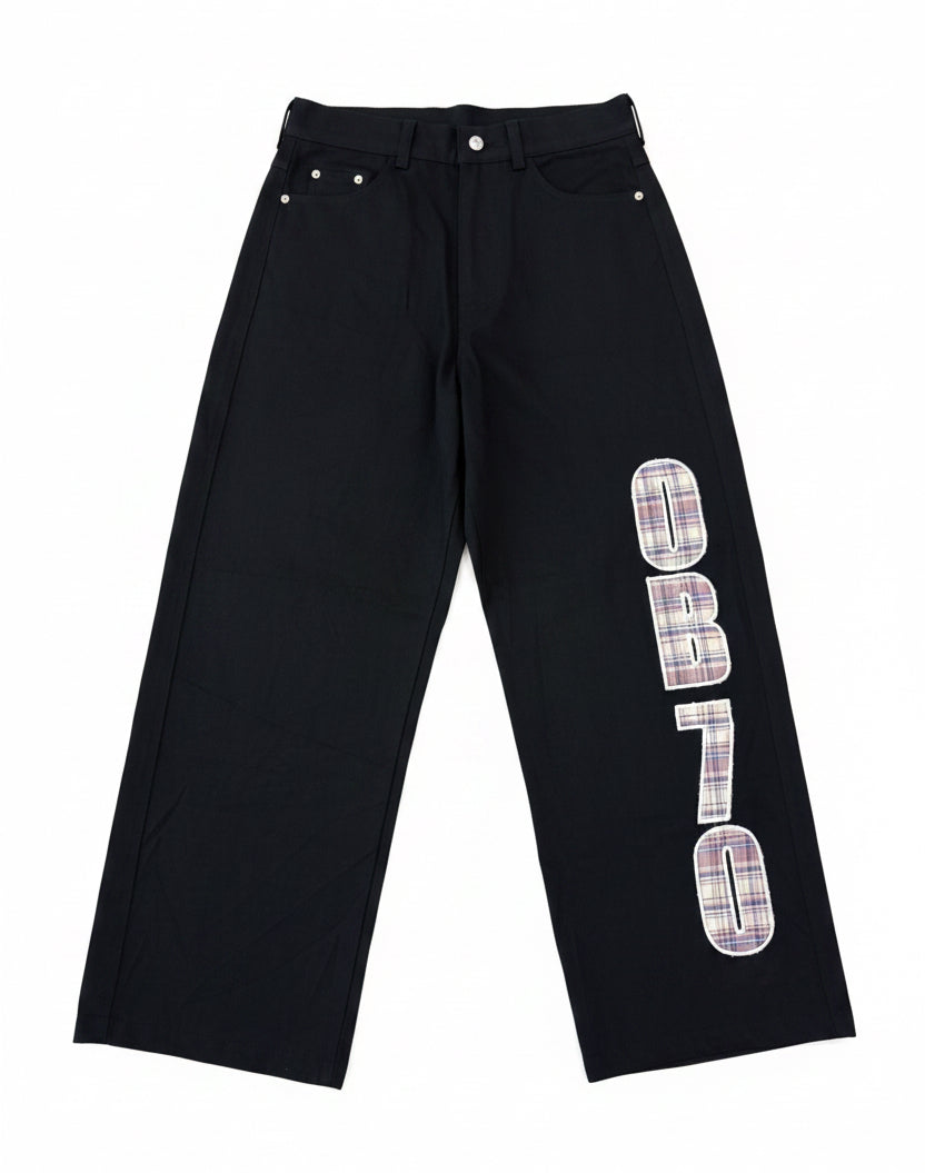 Black OB70 Denim pants with plaid text design on a white background