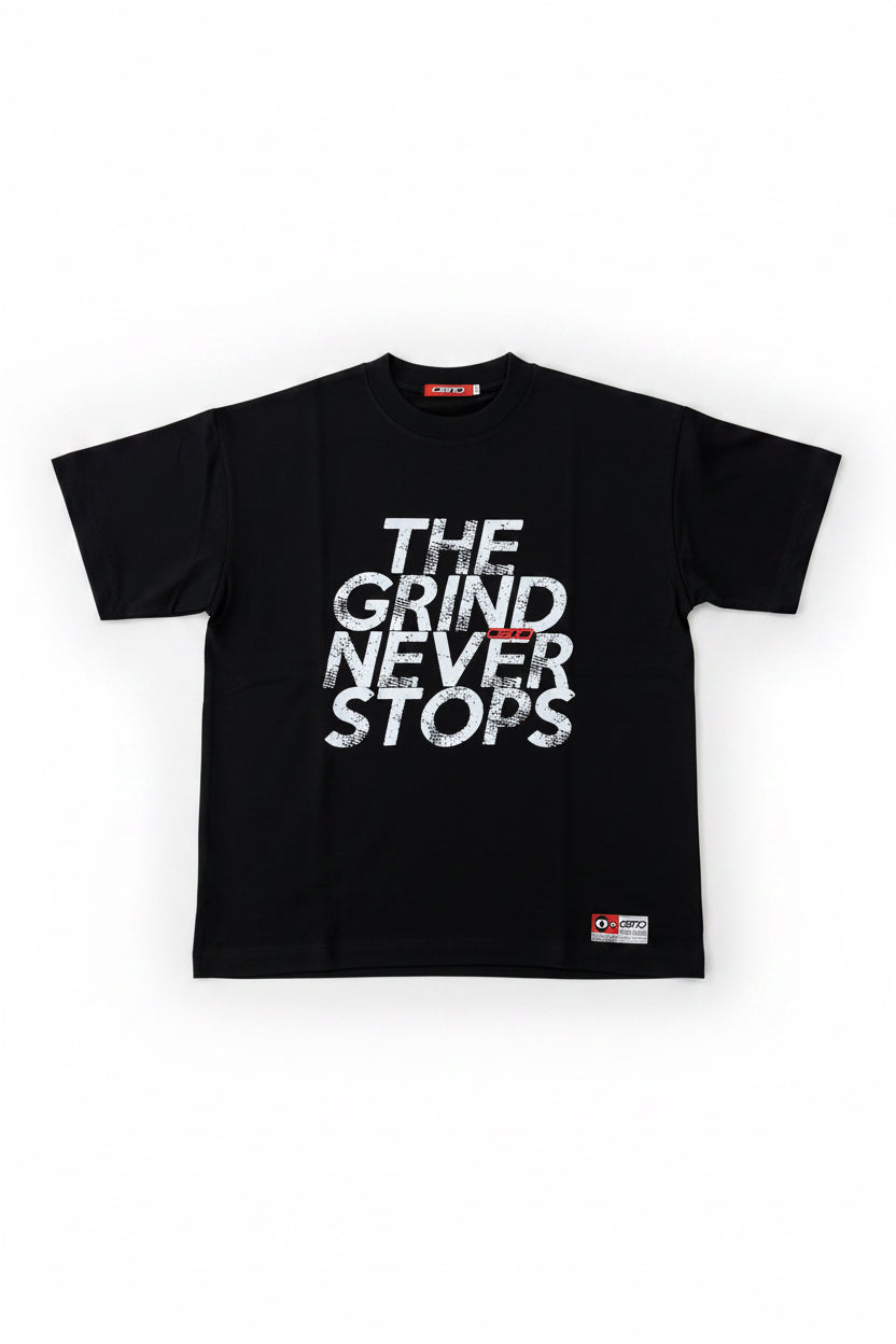 Black OB70  t-shirt with 'The Grind Never Stops' text on a white background
