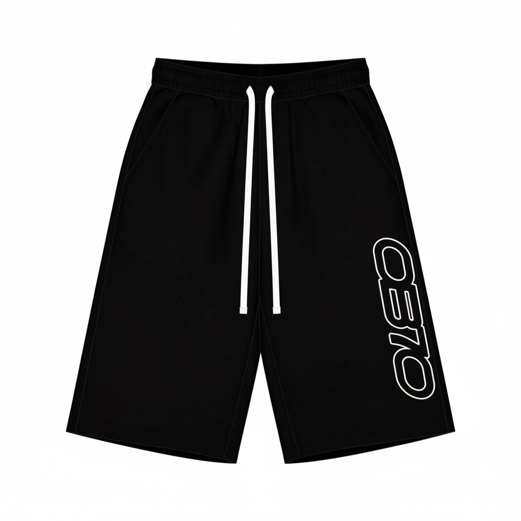 Black athletic shorts shown from the front and back on a plain white background. The front has white drawstrings and a vertical white outlined 'OB70' logo on the left leg, while the back shows a side pocket.
